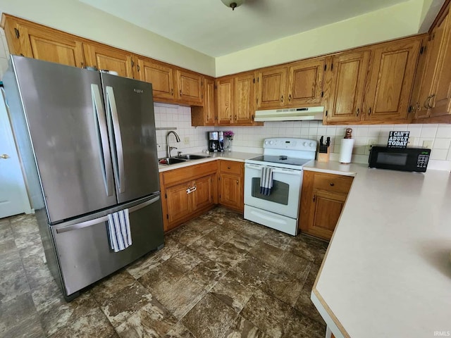 6970 S Maple St, Marion, IN 46953 - kitchen with electric range, freestanding refrigerator, under cabinet range hood, black microwave, and brown cabinetry