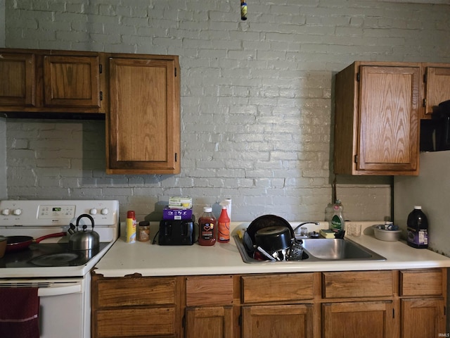 1010-1012 N 9th St, Vincennes, IN 47591 - kitchen featuring electric range, light countertops, and brown cabinets