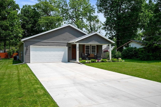 4904 N Hamilton Ln, Muncie, IN 47304 - view of front of home featuring a porch, an attached garage, driveway, and a front yard