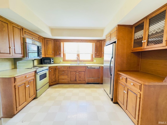 1028 N Wabash Ave, Marion, IN 46952 - kitchen with stainless steel appliances, light floors, brown cabinets, and plenty of natural light