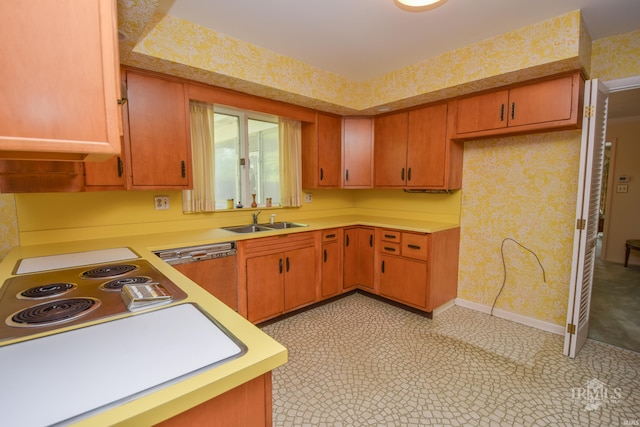 3400 W University Ave, Muncie, IN 47304 - kitchen with dishwasher, wallpapered walls, light countertops, and brown cabinetry