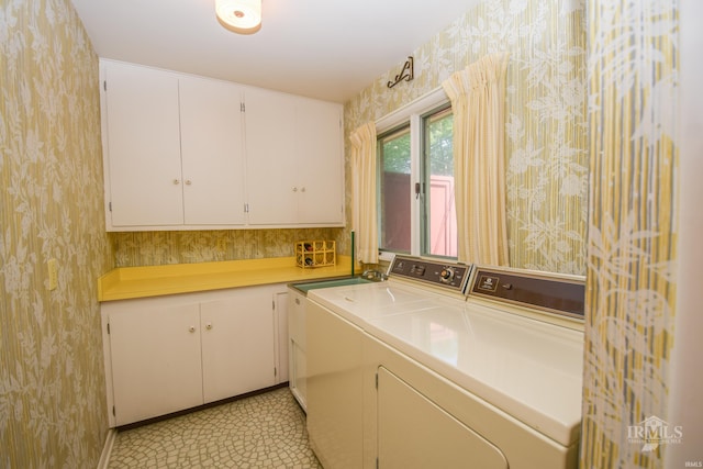3400 W University Ave, Muncie, IN 47304 - laundry area featuring washing machine and dryer, wallpapered walls, and cabinet space