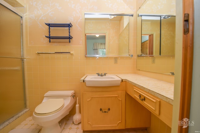 3400 W University Ave, Muncie, IN 47304 - bathroom with vanity, a stall shower, wallpapered walls, tile walls, and tile patterned flooring