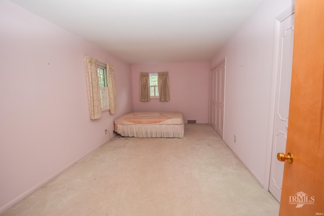 3400 W University Ave, Muncie, IN 47304 - unfurnished bedroom featuring carpet flooring and a closet