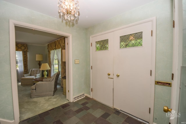 3400 W University Ave, Muncie, IN 47304 - foyer entrance featuring a chandelier and dark carpet