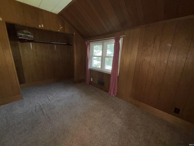 1120 Elm St, Fort Wayne, IN 46808 - unfurnished bedroom with wood walls, vaulted ceiling, carpet flooring, and a closet