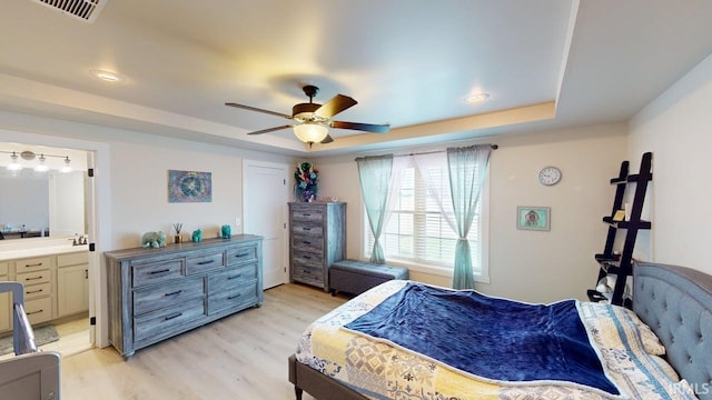 4229 New Birch Dr, Jasper, IN 47546 - bedroom with a raised ceiling, light wood finished floors, ensuite bath, and ceiling fan