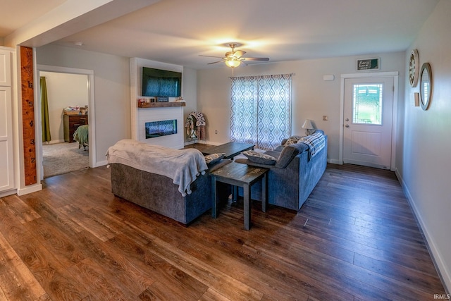 4555 E State Road 66, Cannelton, IN 47520 - living room with a large fireplace, dark wood-style flooring, and a ceiling fan