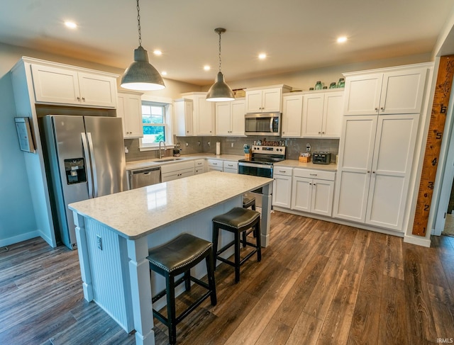 4555 E State Road 66, Cannelton, IN 47520 - kitchen with stainless steel appliances, dark wood-type flooring, a kitchen island, light countertops, and recessed lighting