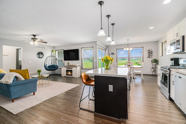 2010 Newbury Cir, Goshen, IN 46526 - kitchen featuring stainless steel appliances, light countertops, open floor plan, a center island, and recessed lighting