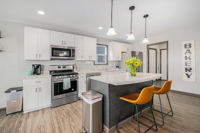 2010 Newbury Cir, Goshen, IN 46526 - kitchen with stainless steel appliances, light countertops, light wood finished floors, and recessed lighting