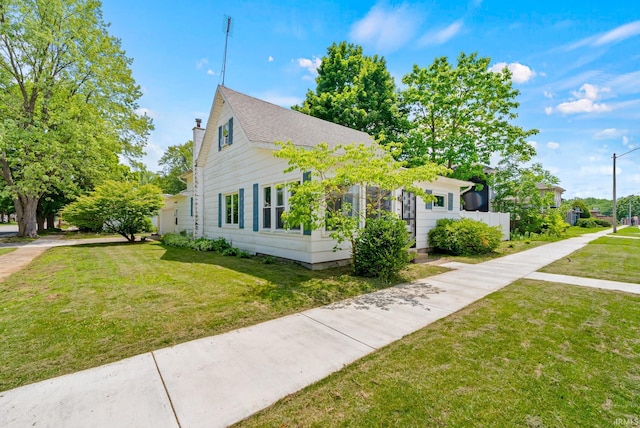 110 N Maple St, South Whitley, IN 46787 - view of side of property featuring a lawn and a chimney