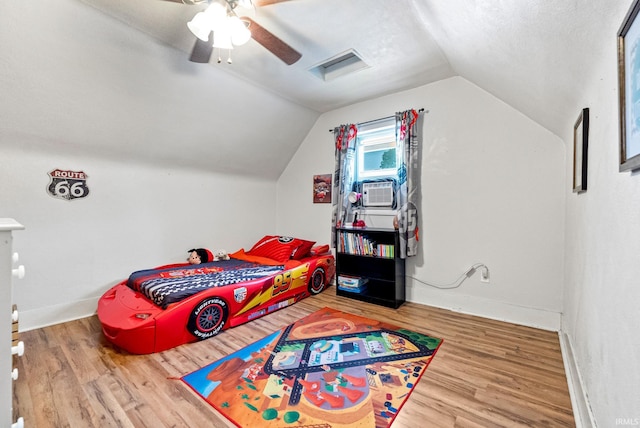 110 N Maple St, South Whitley, IN 46787 - bedroom with cooling unit, wood finished floors, vaulted ceiling, and ceiling fan