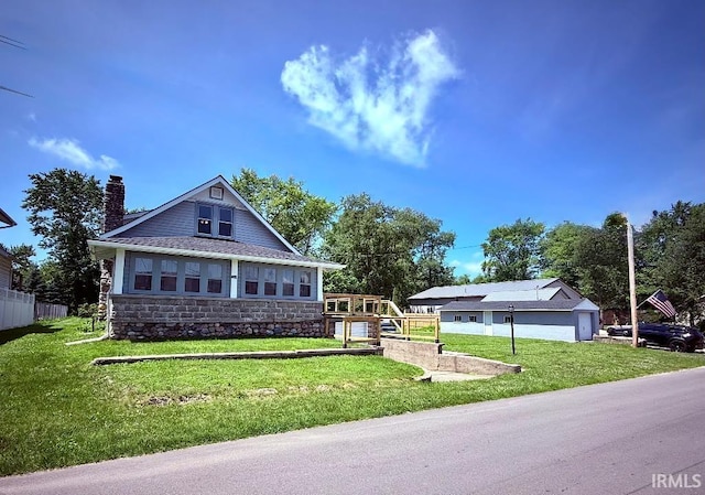 1228 N Main St, Kewanna, IN 46939 - bungalow-style home with stone siding, a chimney, and a front lawn