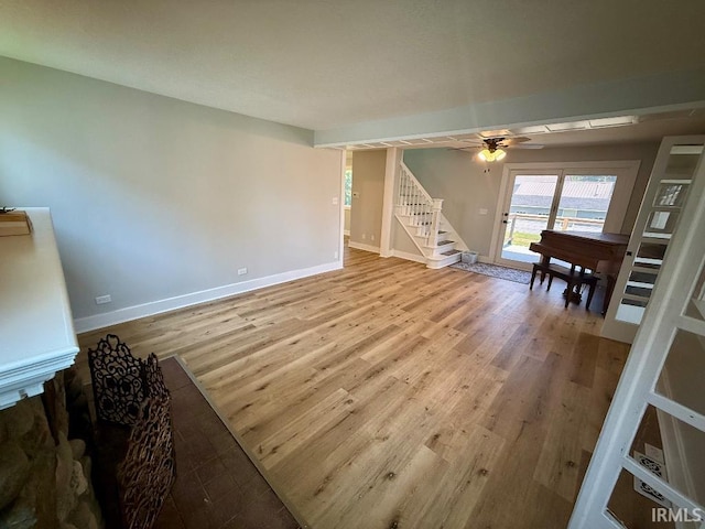 1228 N Main St, Kewanna, IN 46939 - living area with stairway, wood finished floors, and ceiling fan