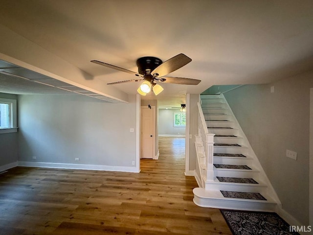 1228 N Main St, Kewanna, IN 46939 - staircase with healthy amount of natural light, wood finished floors, and ceiling fan