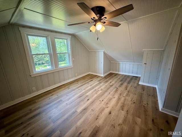 1228 N Main St, Kewanna, IN 46939 - additional living space with wood finished floors, lofted ceiling, ceiling fan, and a decorative wall