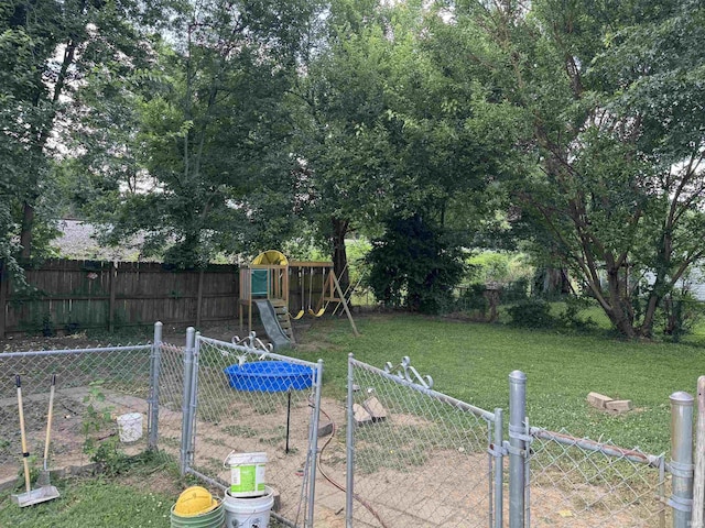 928 E Sherman St, Mount Vernon, IN 47620 - fenced backyard with a playground and a gate