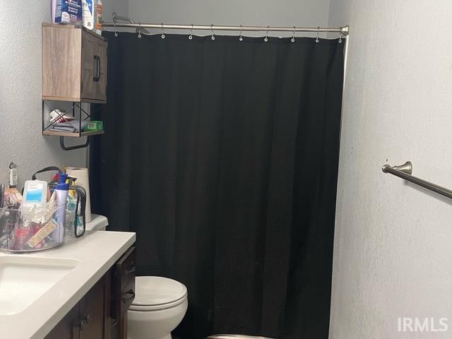928 E Sherman St, Mount Vernon, IN 47620 - full bath with vanity, a shower with shower curtain, and a textured wall