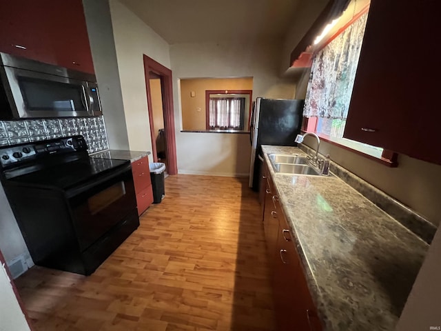 912 Broadway St, Vincennes, IN 47591 - kitchen featuring stainless steel appliances, light wood-style floors, and backsplash