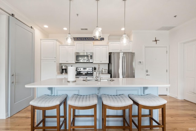 1219 Napoleon St Unit 217, South Bend, IN 46617 - kitchen featuring stainless steel appliances, crown molding, light wood-style floors, light countertops, and white cabinetry