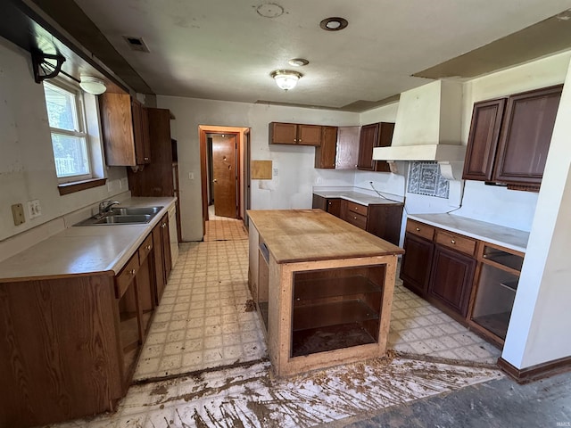4520 Obing Strasse, Jasper, IN 47546 - kitchen featuring light floors, butcher block countertops, a center island, and custom range hood