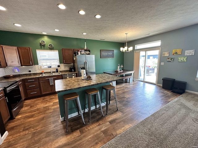 4805 Langhorn Trl, Lafayette, IN 47909 - kitchen with appliances with stainless steel finishes, a kitchen breakfast bar, plenty of natural light, a center island, and recessed lighting