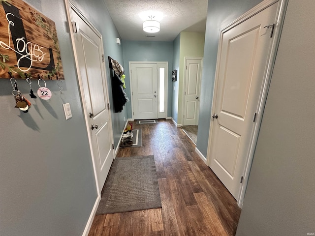 4805 Langhorn Trl, Lafayette, IN 47909 - doorway with dark wood-style flooring and a textured ceiling