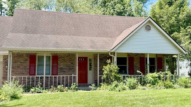 1006 S Carleton Ct, Bloomington, IN 47401 - view of front of house with covered porch, brick siding, a front yard, and roof with shingles