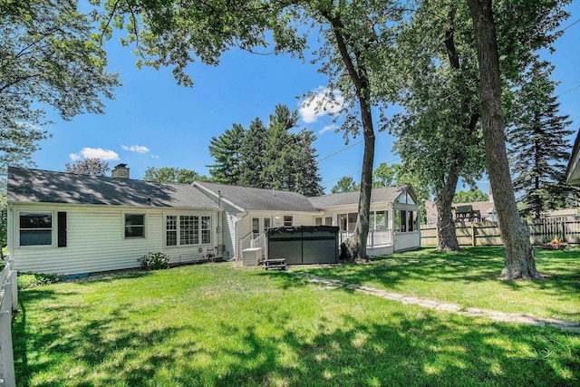 134 Marshall Blvd, Elkhart, IN 46516 - rear view of house featuring a chimney, a hot tub, and a sunroom