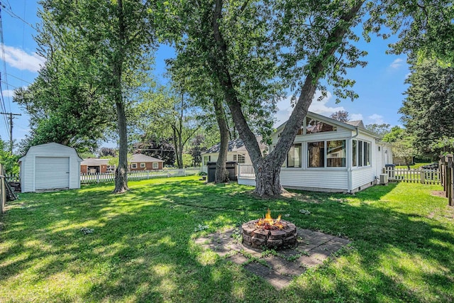 134 Marshall Blvd, Elkhart, IN 46516 - fenced backyard featuring a fire pit and a storage unit