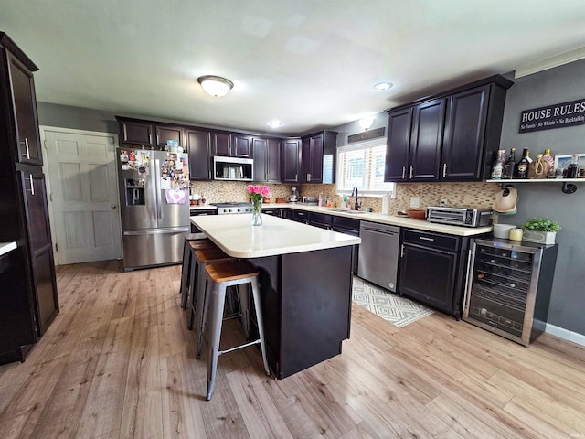 106 N Park Ave, Fowler, IN 47944 - kitchen featuring wine cooler, appliances with stainless steel finishes, light wood-type flooring, light countertops, and recessed lighting