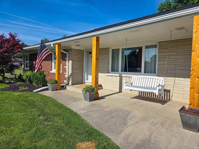 106 N Park Ave, Fowler, IN 47944 - view of front facade featuring brick siding, a front lawn, and covered porch