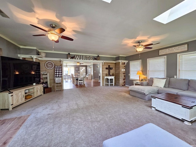 106 N Park Ave, Fowler, IN 47944 - carpeted living room with a ceiling fan, a wood stove, crown molding, and a skylight