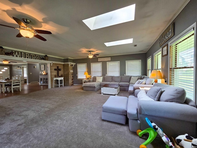 106 N Park Ave, Fowler, IN 47944 - carpeted living room featuring a wood stove, a skylight, plenty of natural light, and ceiling fan