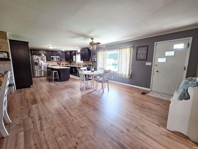 106 N Park Ave, Fowler, IN 47944 - dining space with ceiling fan, light wood-type flooring, and crown molding