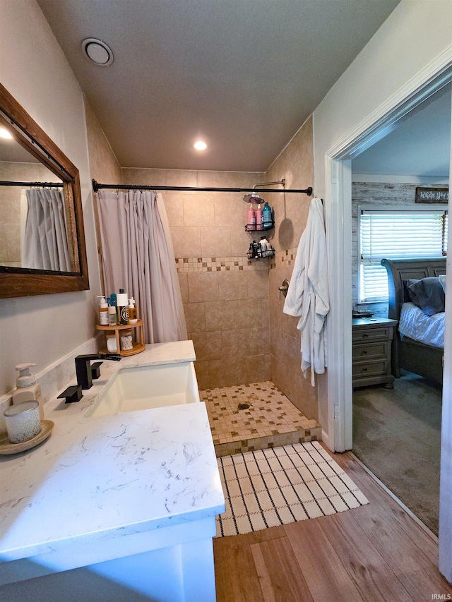 106 N Park Ave, Fowler, IN 47944 - bathroom with connected bathroom, vanity, tiled shower, wood finished floors, and recessed lighting