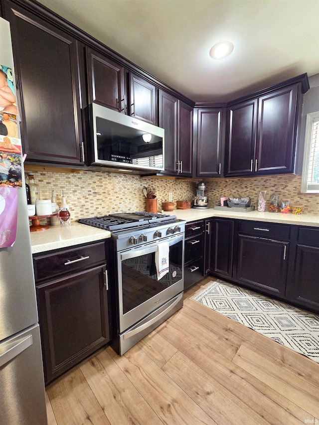 106 N Park Ave, Fowler, IN 47944 - kitchen with appliances with stainless steel finishes, light countertops, decorative backsplash, light wood-type flooring, and dark brown cabinetry