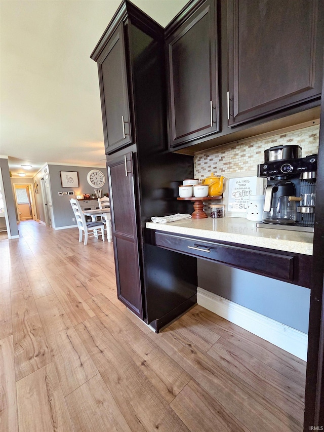 106 N Park Ave, Fowler, IN 47944 - kitchen featuring light wood-type flooring, decorative backsplash, and dark brown cabinetry