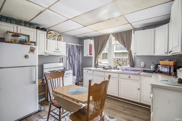 817 Middlebury St, Elkhart, IN 46516 - kitchen with white appliances, a drop ceiling, under cabinet range hood, white cabinets, and wood finished floors
