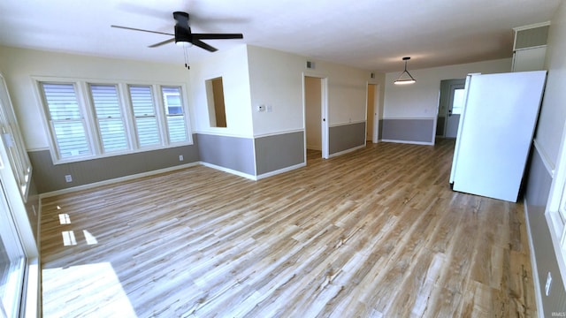 8121 N Tippecanoe Dr, Walkerton, IN 46574 - unfurnished living room with a ceiling fan and light wood finished floors