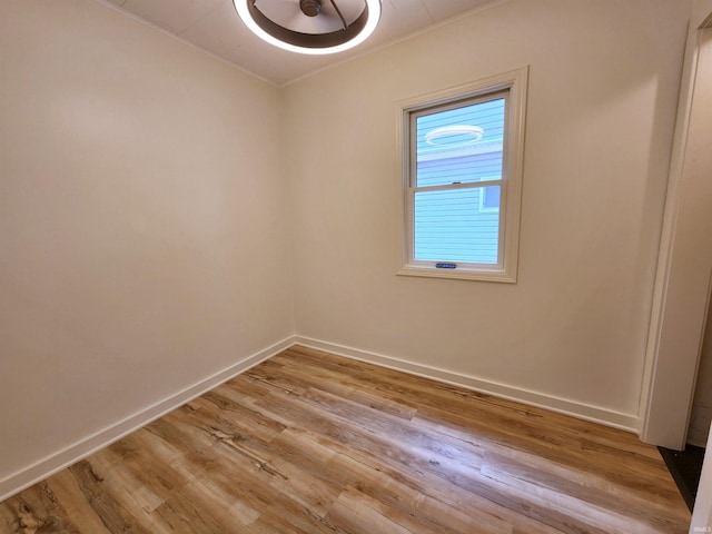 8121 N Tippecanoe Dr, Walkerton, IN 46574 - empty room featuring light wood finished floors and crown molding