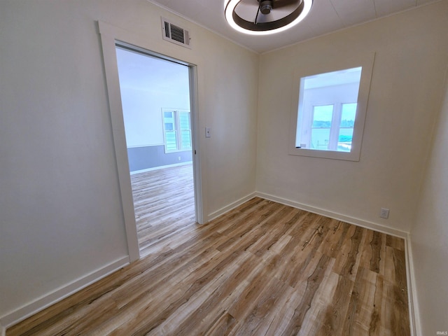 8121 N Tippecanoe Dr, Walkerton, IN 46574 - spare room featuring light wood-style flooring and ceiling fan