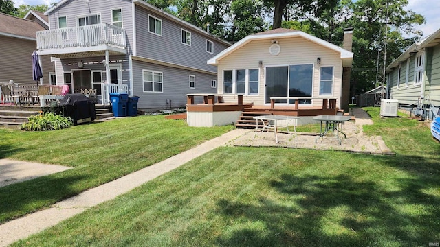 8121 N Tippecanoe Dr, Walkerton, IN 46574 - rear view of property featuring a deck and a lawn