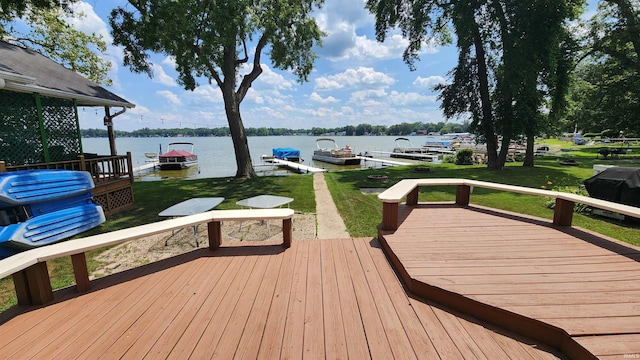 8121 N Tippecanoe Dr, Walkerton, IN 46574 - wooden deck with a water view, a dock, and a lawn