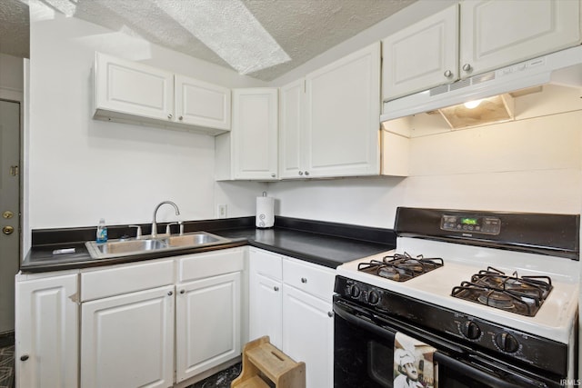 913 W Hubbard Ave, Elkhart, IN 46516 - kitchen with range with gas stovetop, under cabinet range hood, dark countertops, white cabinets, and a textured ceiling
