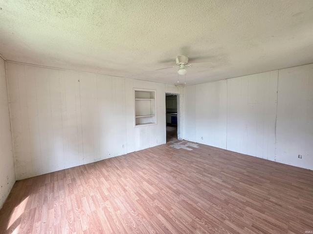 722 N Main St, Sullivan, IN 47882 - unfurnished room with wood finished floors, a textured ceiling, ceiling fan, and wooden walls