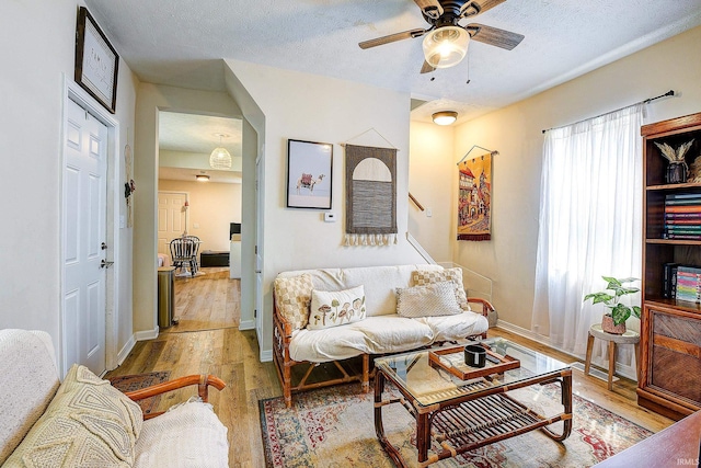 1931 Morton St, Lafayette, IN 47904 - living area with wood finished floors, ceiling fan, a textured ceiling, and stairs