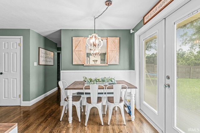 3331 Loral Dr, Anderson, IN 46013 - dining area featuring wood finished floors, a chandelier, and a wainscoted wall