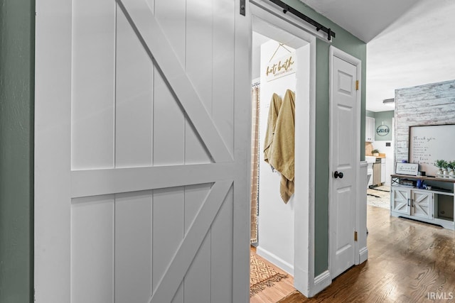 3331 Loral Dr, Anderson, IN 46013 - corridor with a barn door and wood finished floors